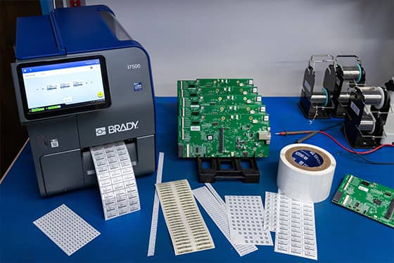 Een werknemer brengt een eigendomslabel aan op een laptop.