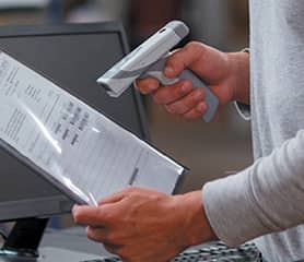 Person scanning a manufacturing document with an RFID scanner